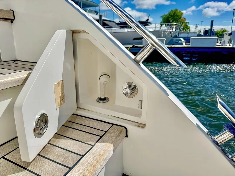 Slide: The Image of 2018 Princess S60 yacht stairs with open storage compartment by the water. - 10