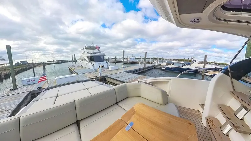 Slide: The Image of Luxurious 2018 Princess S60 yacht docked at marina with spacious seating area. - 7