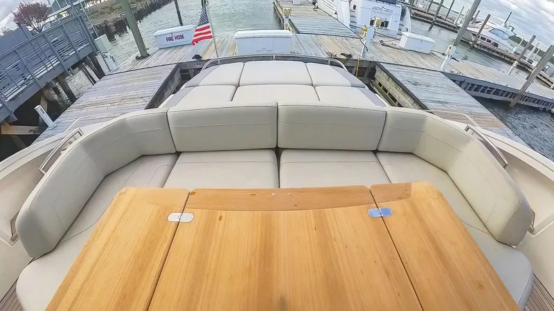 Slide: The Image of Luxurious seating area on a 2018 Princess S60 yacht, docked at a marina. - 8