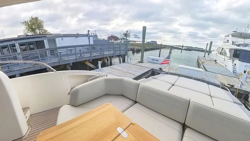 Slide: The Image of Luxurious 2018 Princess S60 yacht docked at a marina with comfortable seating. - 9
