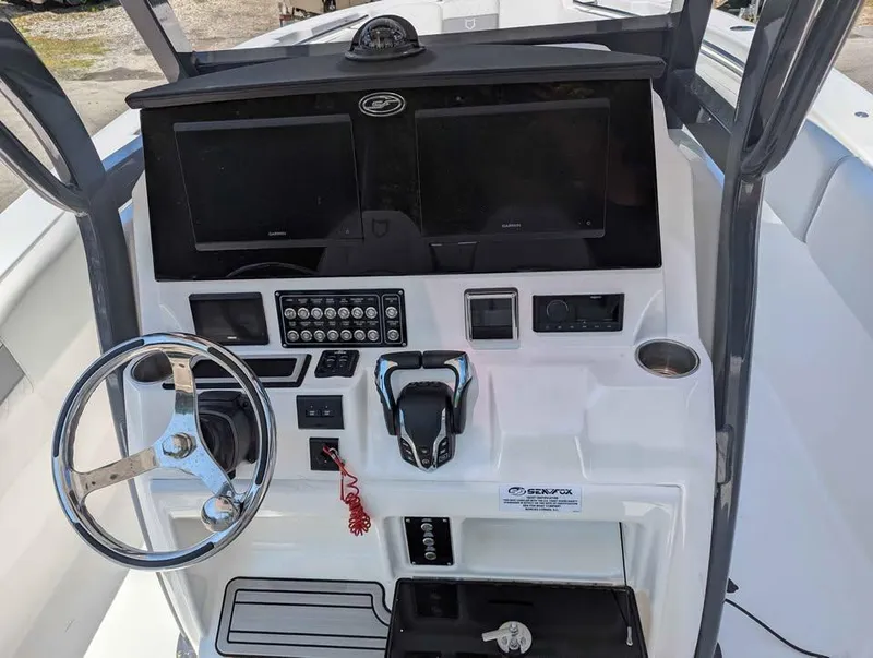Slide: The Image of 2024 Sea Fox 288 Commander helm with dual screens, steering wheel, and controls. - 11