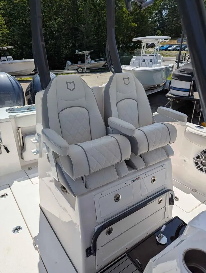 Slide: The Image of 2024 Sea Fox 288 Commander boat seats with quilted design and armrests. - 13