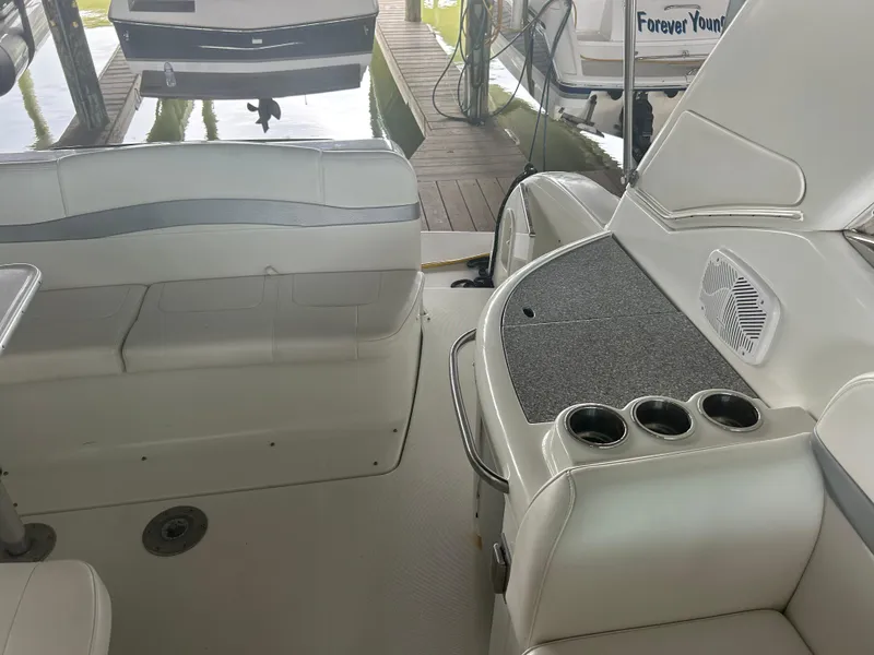 Slide: The Image of 2007 Formula 31 PC boat interior with seating and cup holders in a marina setting. - 15