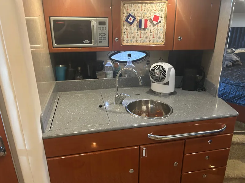 Slide: The Image of 2007 Formula 31 PC yacht kitchenette with microwave, sink, and storage cabinets. - 22