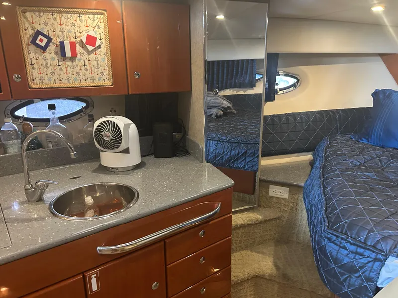 Slide: The Image of 2007 Formula 31 PC cabin interior with kitchenette, sink, and bed. - 23