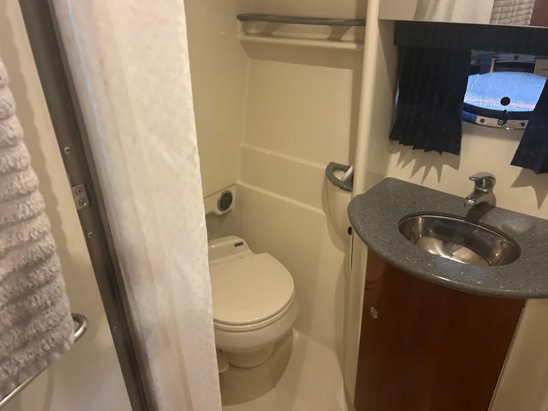 Slide: The Image of 2007 Formula 31 PC boat bathroom with sink, toilet, and porthole window. - 29