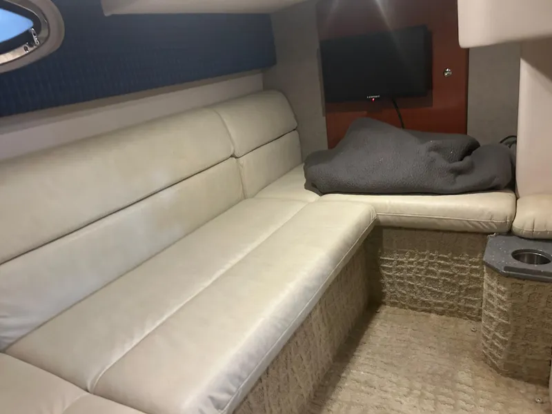 Slide: The Image of 2007 Formula 31 PC cabin interior with beige seating and a mounted TV. - 30