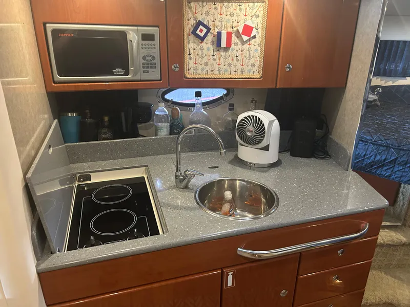 Slide: The Image of 2007 Formula 31 PC yacht kitchen with stove, sink, microwave, and fan. - 33