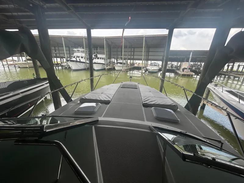 Slide: The Image of 2007 Formula 31 PC yacht docked in a covered marina, surrounded by other boats. - 44