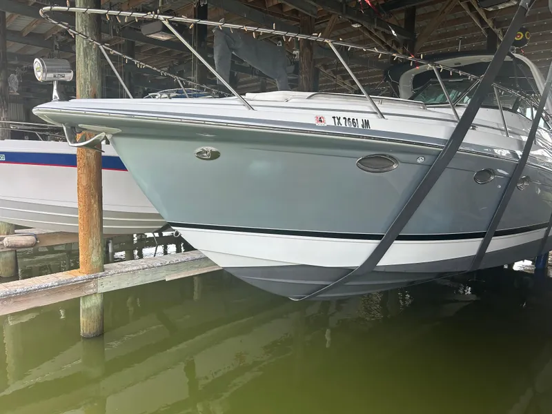 Slide: The Image of 2007 Formula 31 PC boat docked in a marina, partially lifted above water. - 6