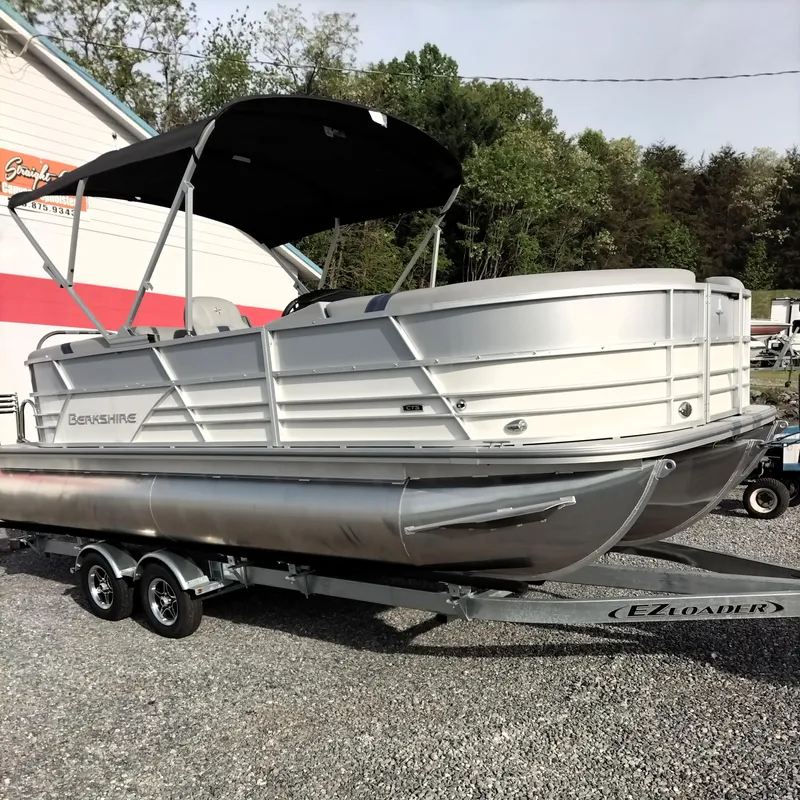 Slide: The Image of 2024 Berkshire 22RFX CTS 2.75 Performance pontoon boat on trailer, parked outdoors. - 9
