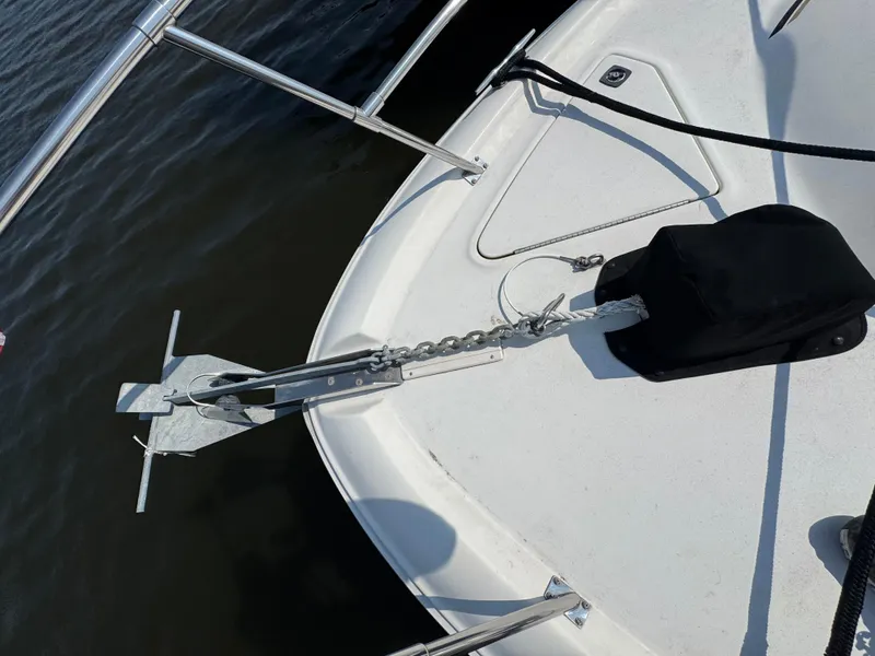Slide: The Image of Bow of 1995 Sea Ray 370 Sundancer with anchor and railing over water. - 10