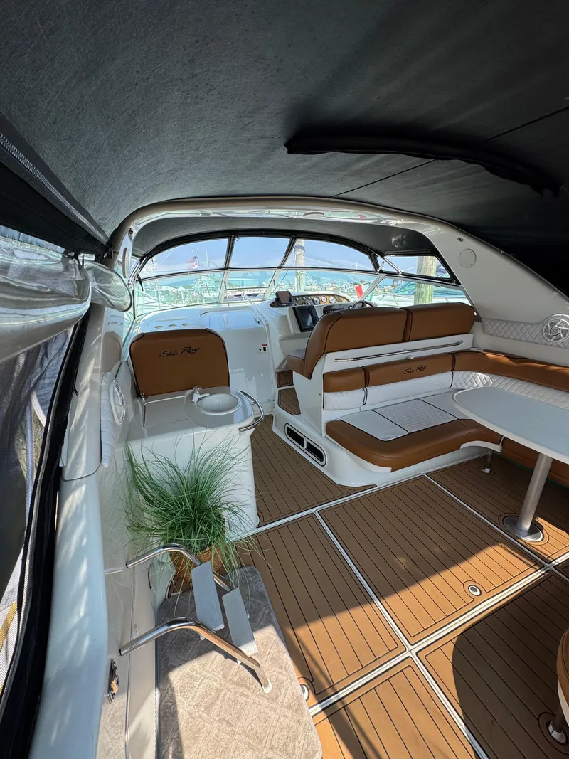 Slide: The Image of Interior of 1995 Sea Ray 370 Sundancer with brown seating and wood flooring. - 13