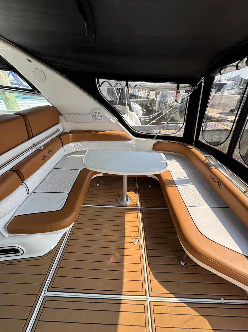 Slide: The Image of 1995 Sea Ray 370 Sundancer interior with brown and white seating, table, and wood-style flooring. - 14