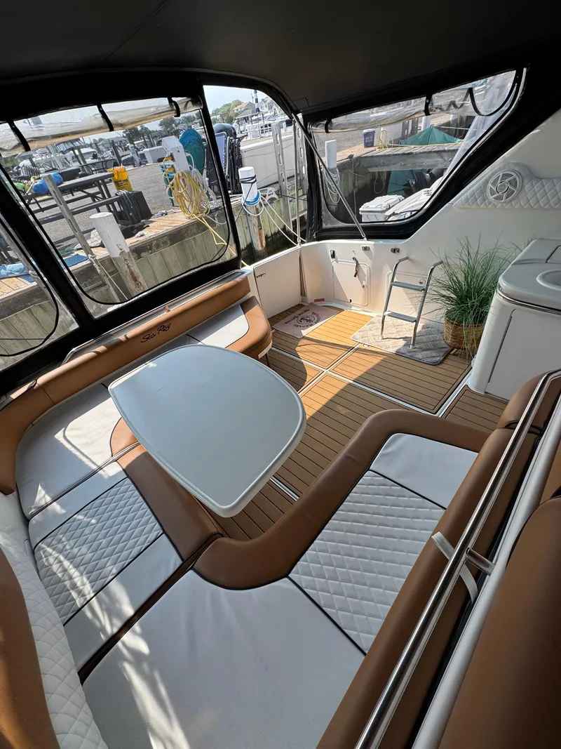 Slide: The Image of 1995 Sea Ray 370 Sundancer interior with seating, table, and wood flooring. - 15
