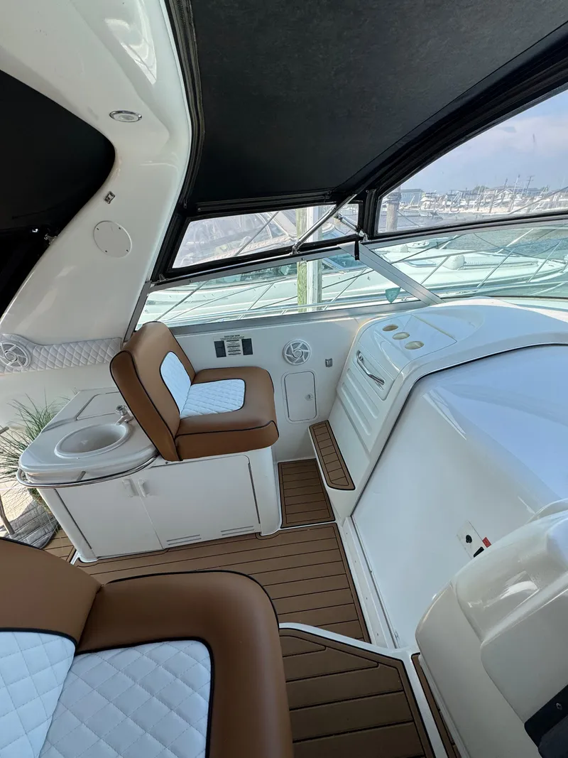 Slide: The Image of Interior of 1995 Sea Ray 370 Sundancer boat with cushioned seating and helm station. - 17