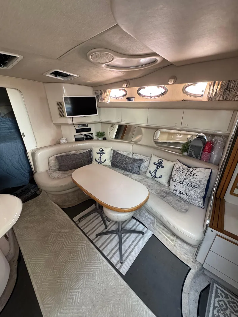 Slide: The Image of Interior of 1995 Sea Ray 370 Sundancer with cozy seating and nautical decor. - 20