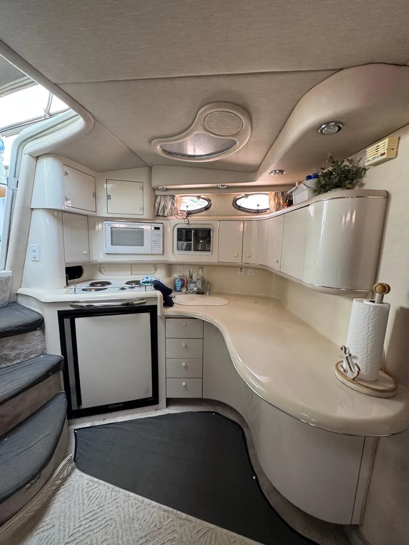 Slide: The Image of Interior of 1995 Sea Ray 370 Sundancer yacht kitchen with modern amenities. - 21