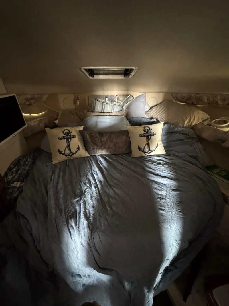 Slide: The Image of Cozy cabin interior of 1995 Sea Ray 370 Sundancer with nautical-themed pillows. - 25