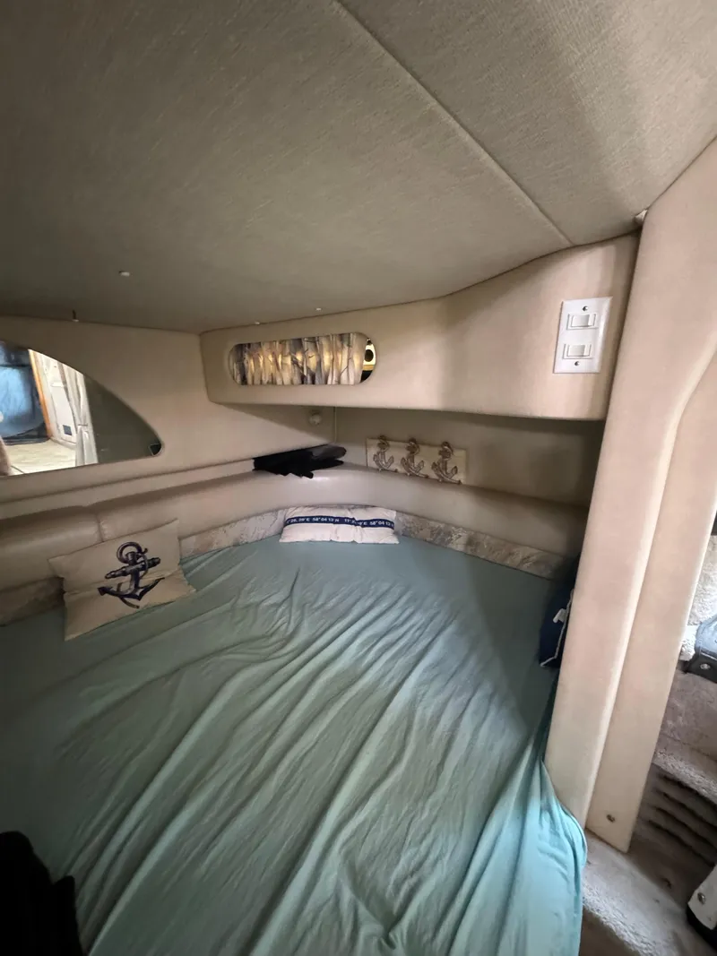 Slide: The Image of Interior cabin of 1995 Sea Ray 370 Sundancer with nautical-themed decor. - 28
