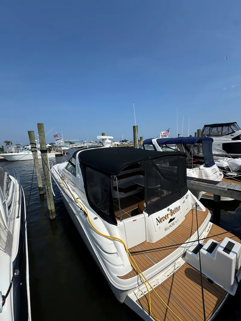 Slide: The Image of 1995 Sea Ray 370 Sundancer docked at marina under clear blue sky. - 3