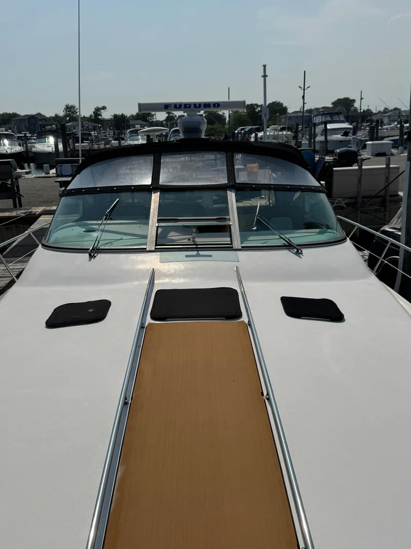 Slide: The Image of 1995 Sea Ray 370 Sundancer yacht docked at a marina, front deck view. - 5