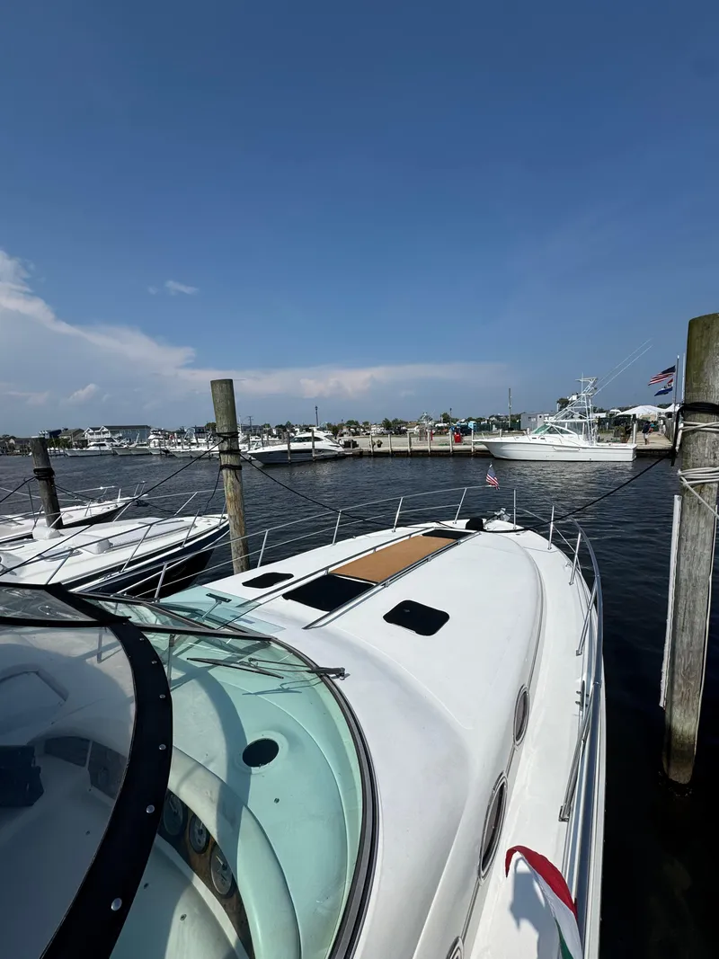 Slide: The Image of Sea Ray 370 Sundancer 1995 docked at marina under clear blue sky. - 6
