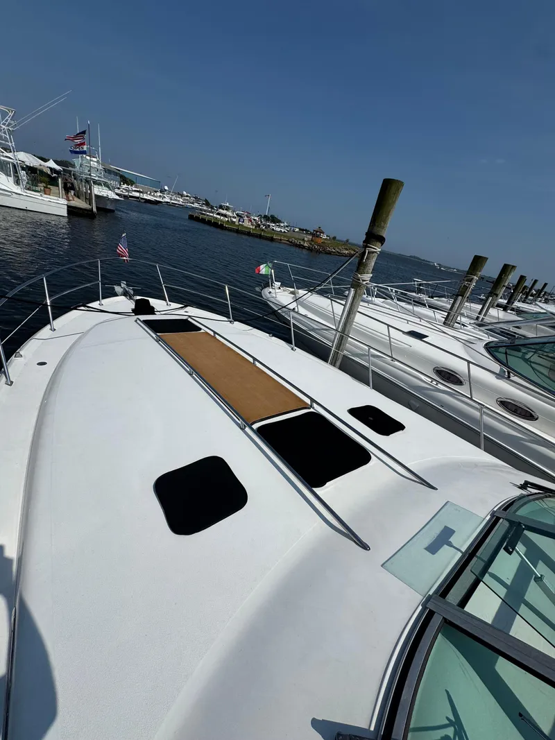 Slide: The Image of 1995 Sea Ray 370 Sundancer yacht docked at marina under clear blue sky. - 7