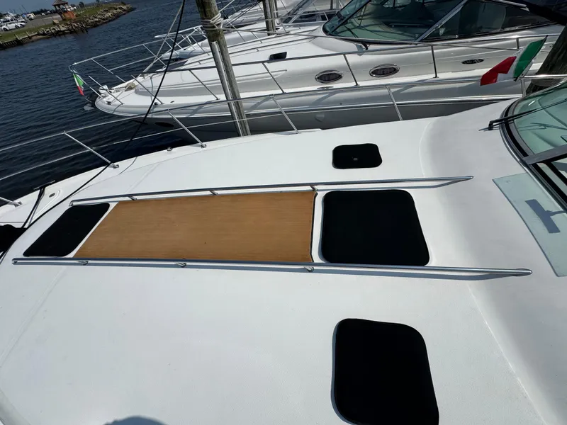 Slide: The Image of 1995 Sea Ray 370 Sundancer yacht docked, featuring sleek deck design and modern amenities. - 8