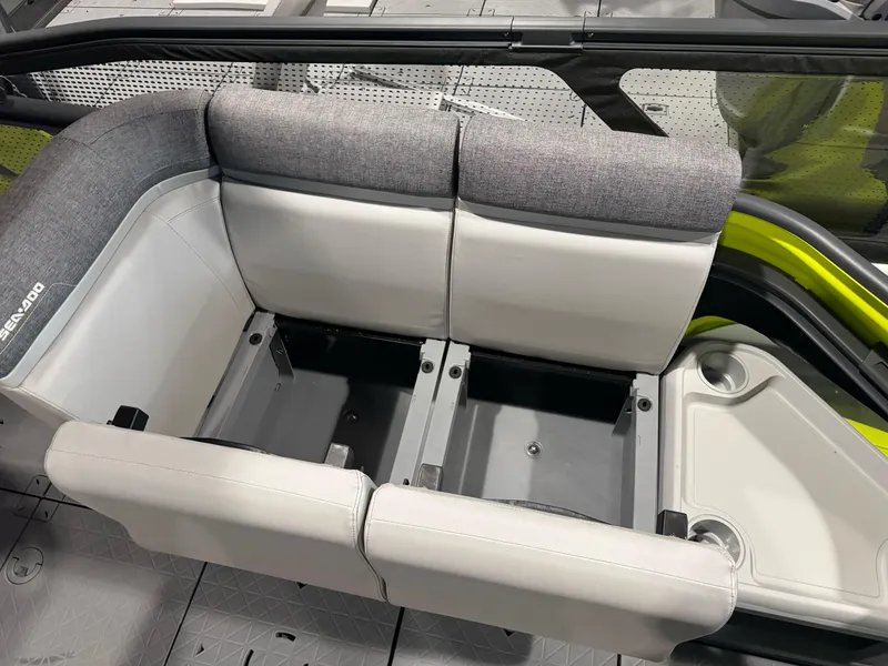 Slide: The Image of 2025 Sea-Doo Switch Cruise 18 interior seating with storage compartments and cup holders. - 12