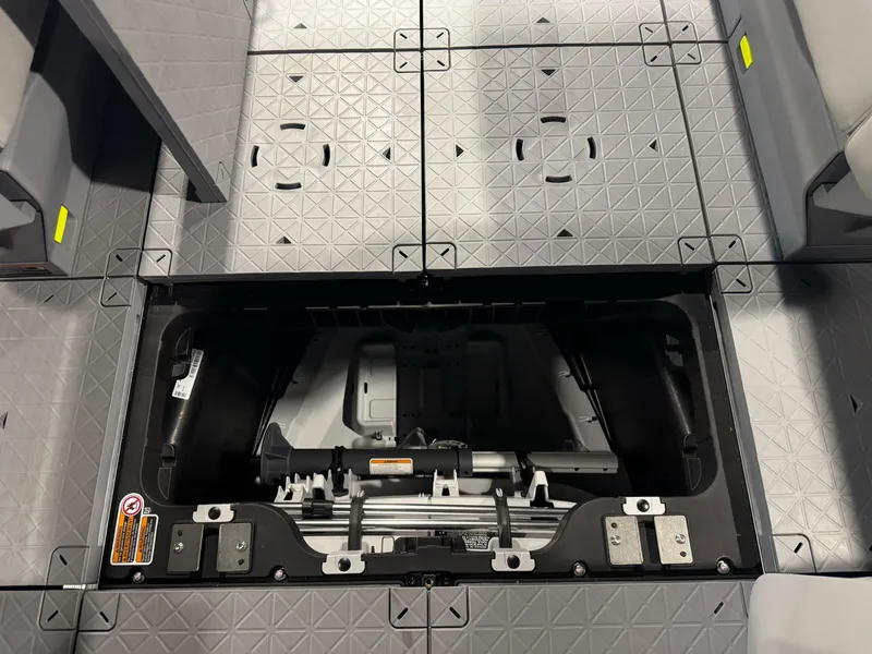 Slide: The Image of 2025 Sea-Doo Switch Cruise 18 storage compartment with open hatch, showcasing interior design. - 13