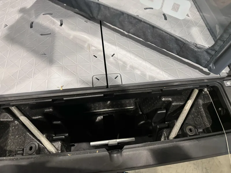 Slide: The Image of 2025 Sea-Doo Switch Cruise 18 storage compartment with textured flooring and structural components. - 17