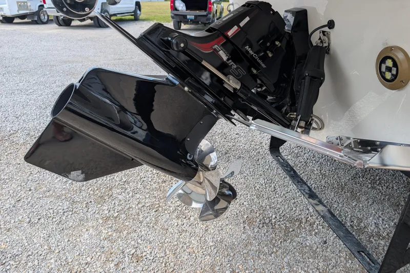 Slide: The Image of 2026 Sea Ray SDX 230 Surf boat engine and propeller on gravel surface. - 10