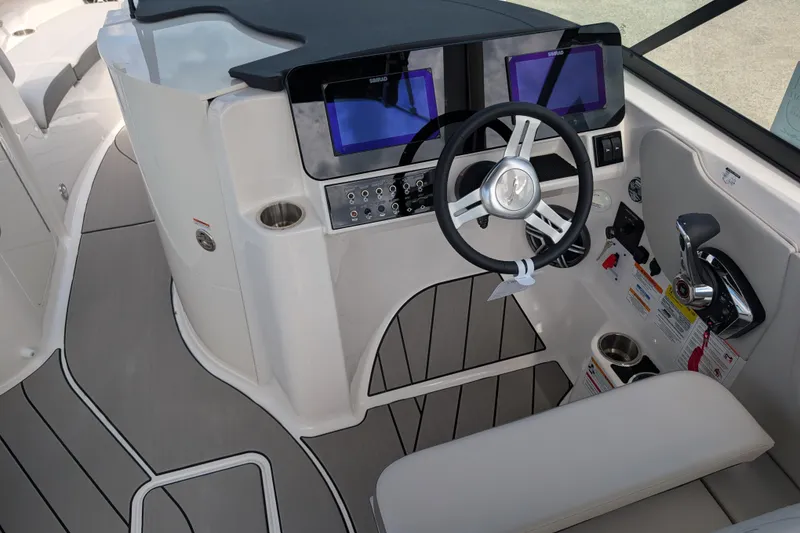 Slide: The Image of 2026 Sea Ray SDX 230 Surf boat cockpit with modern controls and dual screens. - 13