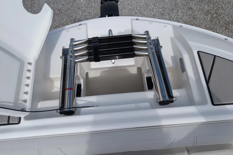 Slide: The Image of 2026 Sea Ray SDX 230 Surf boat with stainless steel ladder and storage compartment. - 17