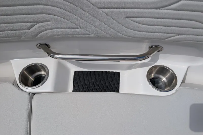 Slide: The Image of 2026 Sea Ray SDX 230 Surf boat interior with cup holders and grab handle. - 19