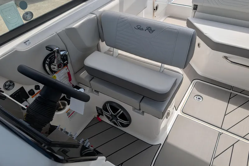 Slide: The Image of 2026 Sea Ray SDX 230 Surf boat interior with steering wheel and seating. - 21