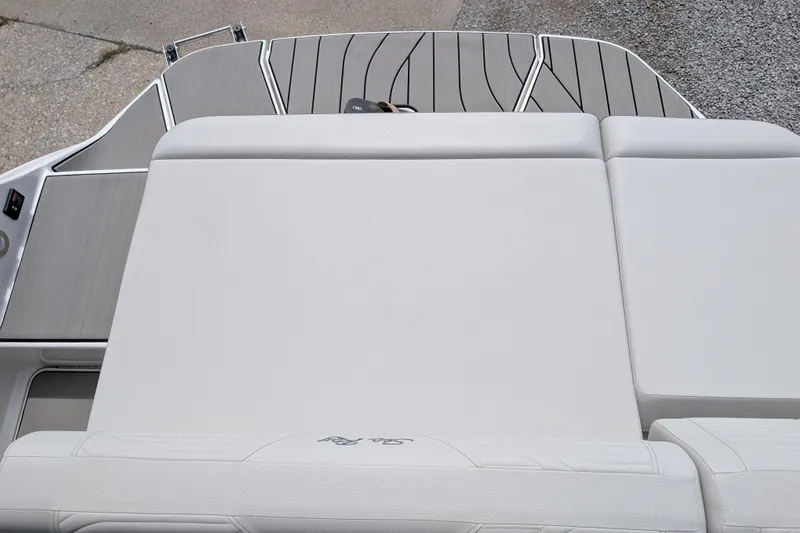Slide: The Image of 2026 Sea Ray SDX 230 Surf boat with sleek white seating and deck design. - 23