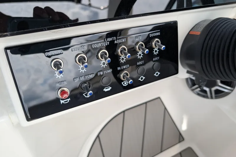 Slide: The Image of Control panel of 2026 Sea Ray SDX 230 Surf boat with various switches and buttons. - 30