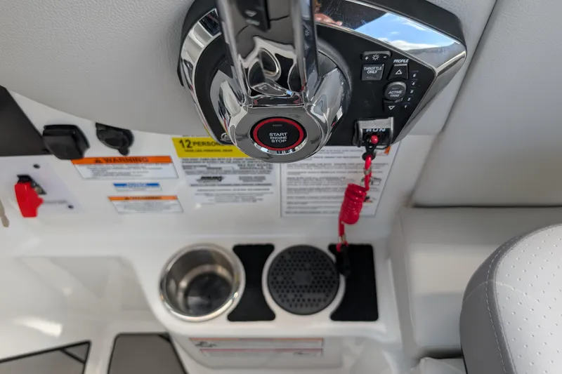 Slide: The Image of Control panel of 2026 Sea Ray SDX 230 Surf boat with start button and cup holder. - 31