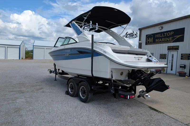 Slide: The Image of 2026 Sea Ray SDX 230 Surf boat on trailer at Hilltop Marine dealership. - 7