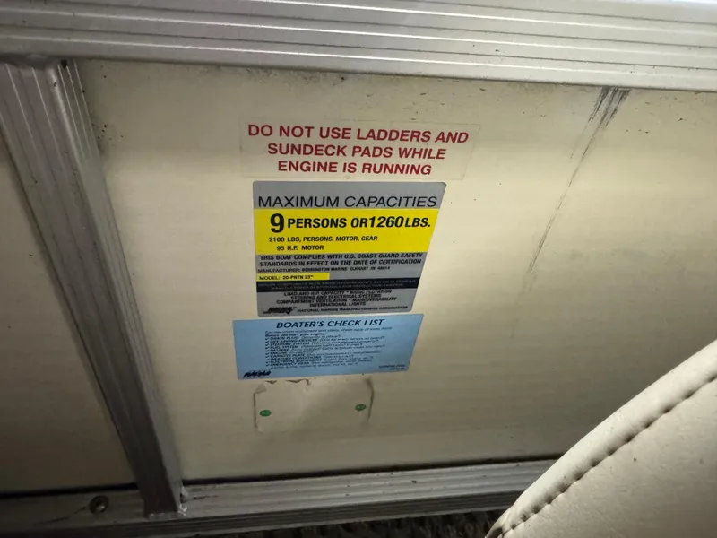 Slide: The Image of Capacity warning label on 2003 Bennington 205L boat, maximum 9 persons or 1260 lbs. - 13