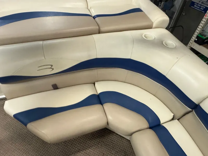 Slide: The Image of Beige and blue seating on a 2003 Bennington 205L boat, featuring cup holders. - 9