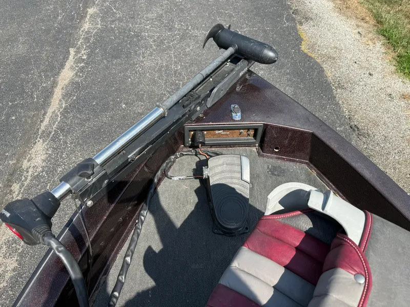 Slide: The Image of 1992 Ranger 320v boat interior with trolling motor and seat on asphalt. - 7