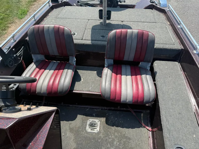 Slide: The Image of 1992 Ranger 320v boat interior with red and gray striped seats. - 9