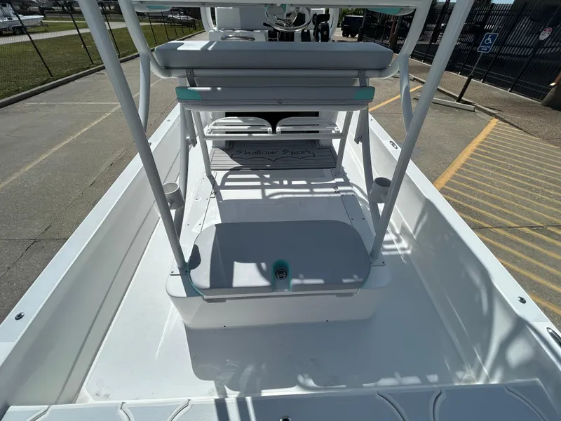 Slide: The Image of 2024 Shallow Sport 24 Modified V boat interior with seating and console. - 10