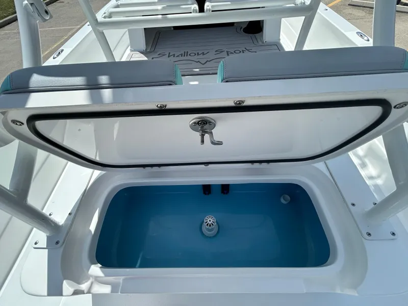 Slide: The Image of 2024 Shallow Sport 24 Modified V boat with open storage compartment. - 11