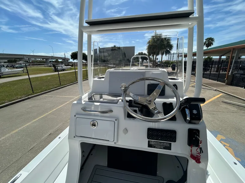 Slide: The Image of 2024 Shallow Sport 24 Modified V boat console with steering wheel and controls. - 13