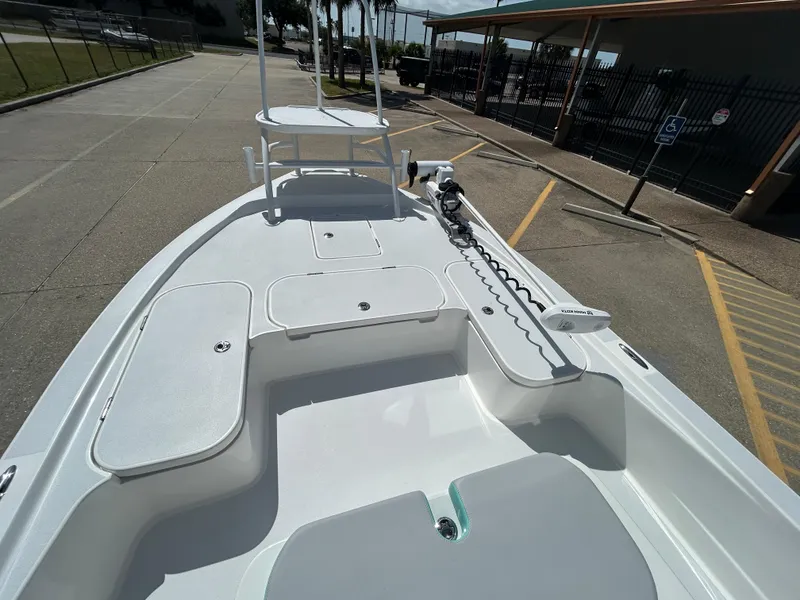 Slide: The Image of 2024 Shallow Sport 24 Modified V boat deck with storage compartments and trolling motor. - 16