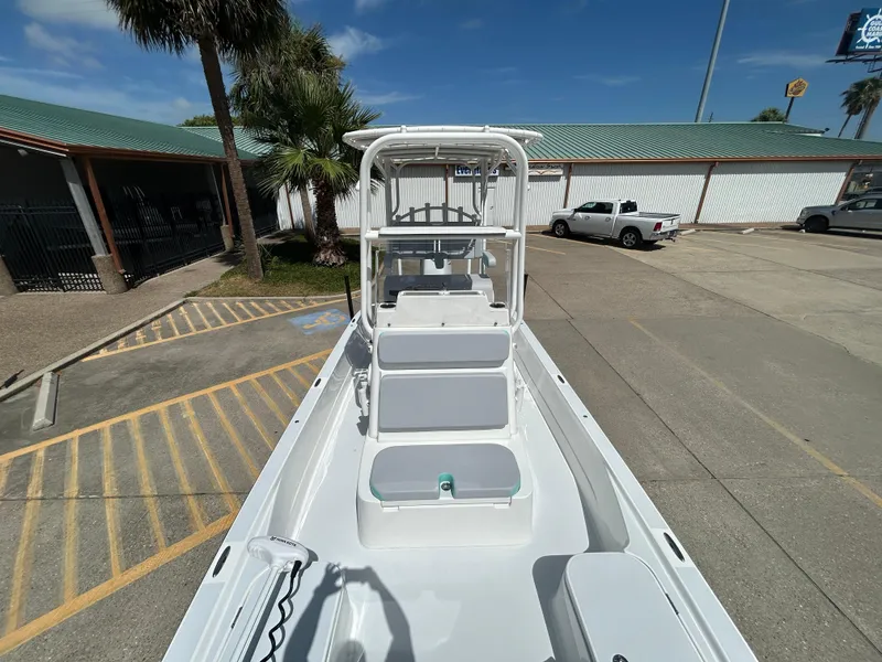 Slide: The Image of 2024 Shallow Sport 24 Modified V boat in parking lot, showcasing sleek design and spacious deck. - 17